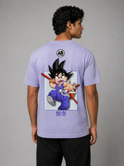 Back view of a male model wearing a lavender classic-fit cotton T-shirt against a light gray studio background, featuring a centered anime graphic of a young warrior character in motion with Japanese text below and a small circular symbol near the upper back.
