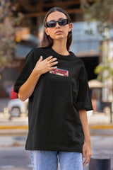 Streetwear model wearing the unisex NOA Shizuku-tan oversized anime t-shirt, styling the My Dress-Up Darling graphic tee with dark urban apparel.