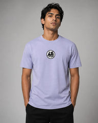 Man wearing a light purple t-shirt with a black and white symbol on a gray background