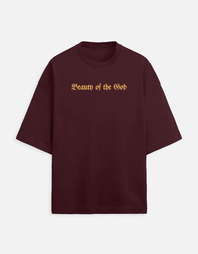 Front view of the Noir - Lethal Cupid maroon oversized streetwear t-shirt highlighting the intricate DTF grayscale cherub and gold typography print.