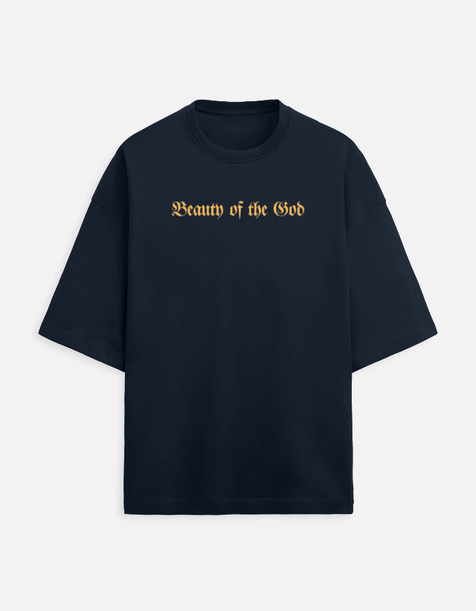 Front view of the Noir - Lethal Cupid oversized navy blue streetwear t-shirt featuring a grayscale angel holding a rifle and gold Gothic typography