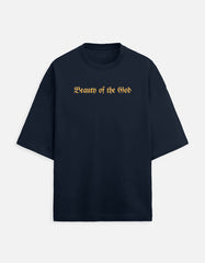 Front view of the Noir - Lethal Cupid oversized navy blue streetwear t-shirt featuring a grayscale angel holding a rifle and gold Gothic typography